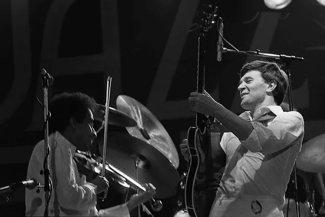 John McLaughlin and L. Shankar on stage at Jazz Bilzen in 1978