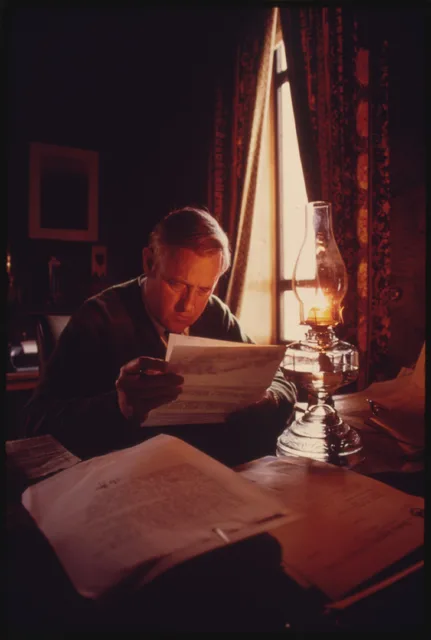 Oregon governor Tom McCall using a kerosene lamp